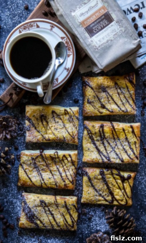 Maple Chocolate Glazed Pumpkin Coffee Danish 2 A stunning top-down view of a plate featuring a freshly baked Pumpkin Coffee Danish with rich Chocolate Maple Icing, highlighting its golden pastry and creamy filling.