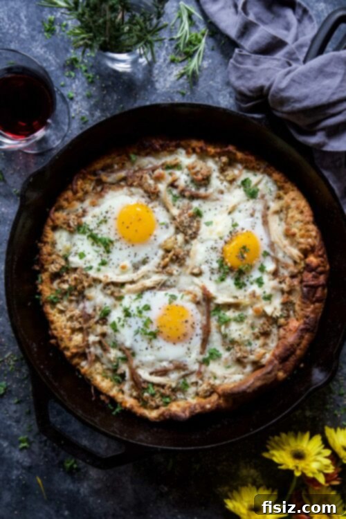 Post-Thanksgiving Dutch Baby Pizza 2 Puffy golden Dutch Baby base topped with Thanksgiving leftovers like turkey, stuffing, cranberry, and baked eggs