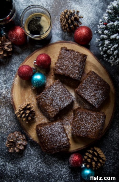 Gingerbread Stout Squares elegantly arranged on a serving plate with powdered sugar dusting