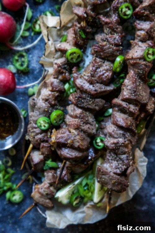Lemongrass Vietnamese Beef Skewers 3 Close-up of freshly grilled Spiced Vietnamese-Style Beef Skewers with vibrant garnishes.