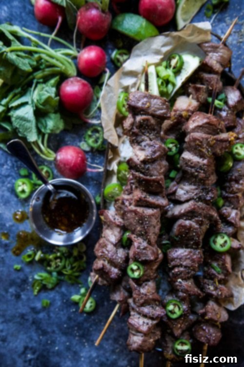 Lemongrass Vietnamese Beef Skewers 4 Prep shot: Beef cubes being threaded onto skewers, ready for grilling.