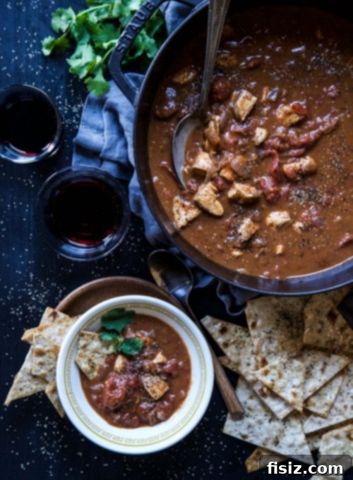 Rich Tomato Chicken Curry with Crispy Garlic Lavash 5 A large pot of simmering Tomato Chicken Curry, rich in color and texture, ready to be served.