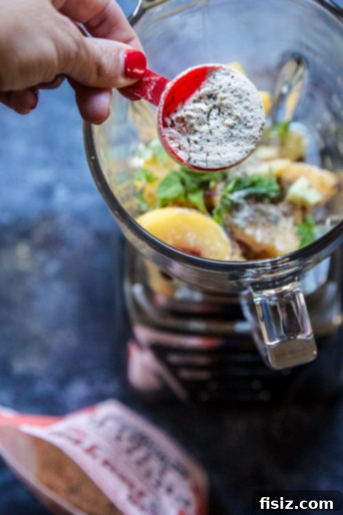 Zesty Citrus Ginger Smoothie 4 A glass of Grapefruit-Ginger Burst Smoothie, adorned with a slice of grapefruit and a sprig of mint, ready to be enjoyed.
