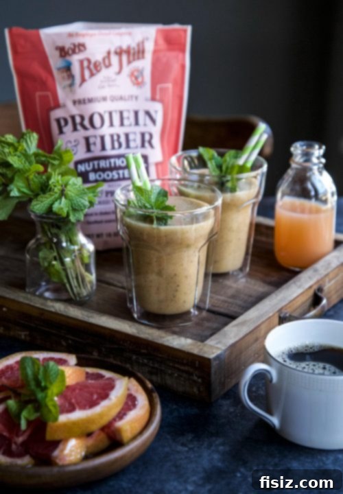 Zesty Citrus Ginger Smoothie 6 A refreshing Grapefruit-Ginger Burst Smoothie being poured into a glass, highlighting its vibrant color and smooth texture.