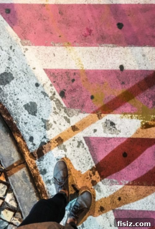Lisbon Revealed: Your Guide to Stays, Bites, and Sights 21 Pink Street at night, illuminated by neon lights from bars