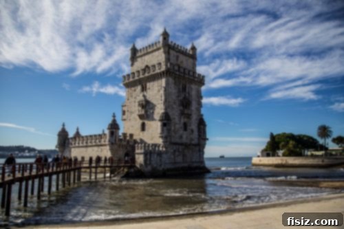 Lisbon Revealed: Your Guide to Stays, Bites, and Sights 23 The historic Belém Tower standing by the Tagus River under a clear sky