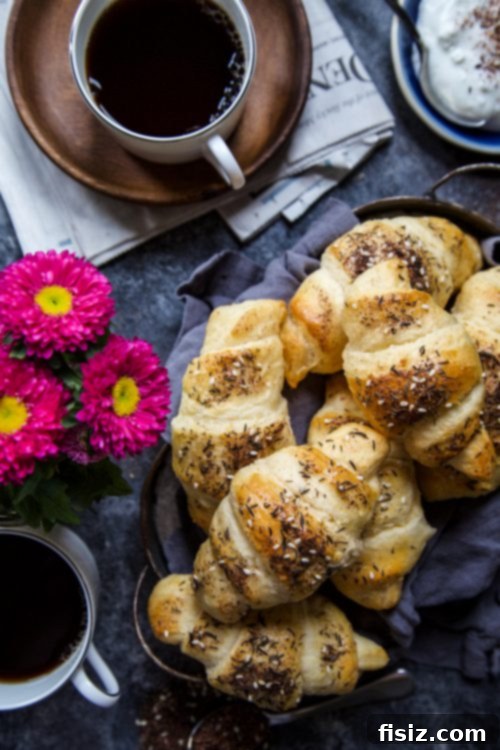 Easy Za'atar Croissants with Labneh 4 Croissants being prepared with egg wash and za'atar seasoning.