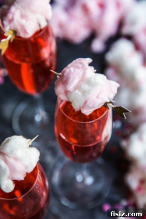 Pink Fizz with Champagne Cotton Candy Cloud 4 Champagne cotton candy and limeade in a glass.