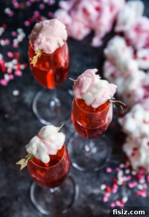 Pink Fizz with Champagne Cotton Candy Cloud 5 Close-up of champagne cotton candy melting into a pink limeade cocktail.