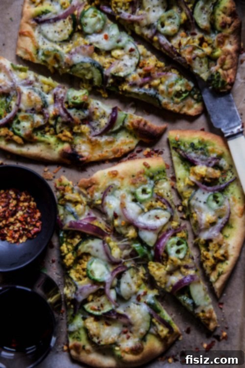 Masala Turkey Pizza 6 Multiple slices of Indian Spiced Turkey Pizza on a serving board.
