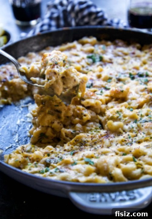 Zesty Crispy Brussels Sprout Mac and Cheese 4 A serving of Crispy Lemon Brussels Sprouts Mac & Cheese in a white bowl, garnished with fresh parsley.
