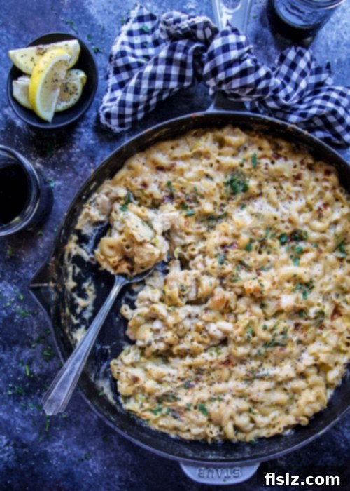 Zesty Crispy Brussels Sprout Mac and Cheese 5 Close-up of the Crispy Lemon Brussels Sprouts Mac & Cheese in a skillet, showcasing its golden-brown top from the broiler.