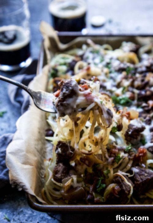 Guinness and Black Bean Chili Fries 5 Close-up view of crispy spiralized fries generously topped with Guinness Black Bean Chili and melted mozzarella cheese
