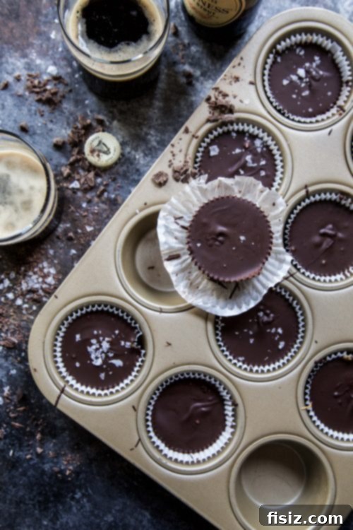 Dark Chocolate Stout Peanut Butter Cups 3 Close-up of a partially unwrapped Dark Chocolate Peanut Butter Guinness Cup, showing the rich layers of chocolate and peanut butter
