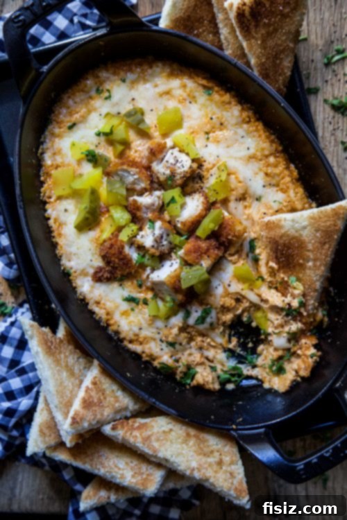 Sweet Heat Chicken Dip with Honey Butter Toasts 4 Close-up of creamy Hot Chicken Dip with crispy fried chicken pieces.