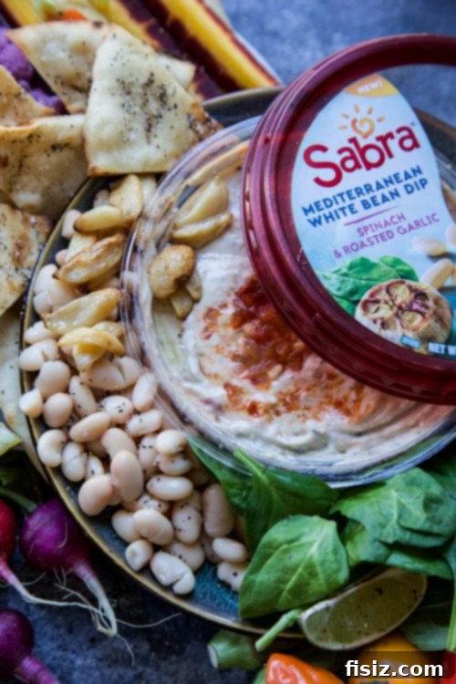 Mediterranean Bean Mezze Platter 3 Close-up of Sabra White Bean with Spinach & Roasted Garlic dip, showing its creamy texture and visible pieces of spinach and garlic.