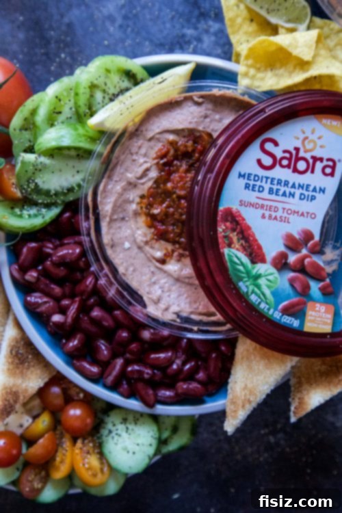 Mediterranean Bean Mezze Platter 4 Close-up of Sabra Red Bean with Sundried Tomato & Basil dip, showcasing its rich color and flecks of herbs and tomatoes.
