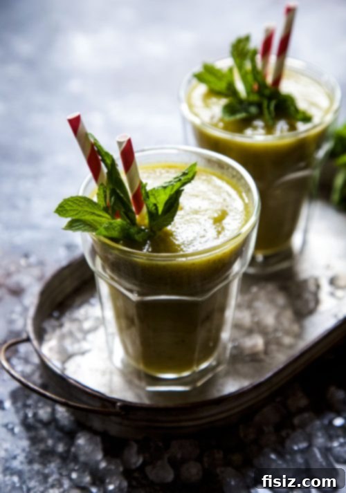 Vibrant Turmeric Pineapple Kiwi Mint Smoothie 6 Final presentation of Kiwi Pineapple Turmeric Smoothie with mint garnish