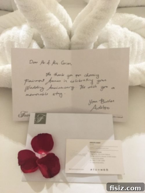 Amman Your Ultimate Stay Guide 11 Anniversary setup in a Fairmont Amman room with towel swans and chocolates