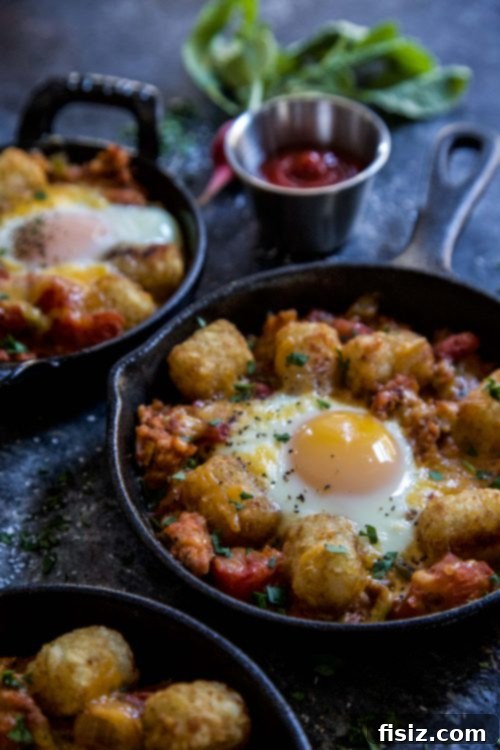 Crispy Tot Shakshuka 4 A rustic cast-iron pan filled with Tot Shakshuka, eggs perfectly set in a rich tomato sauce, topped with golden tater tots.