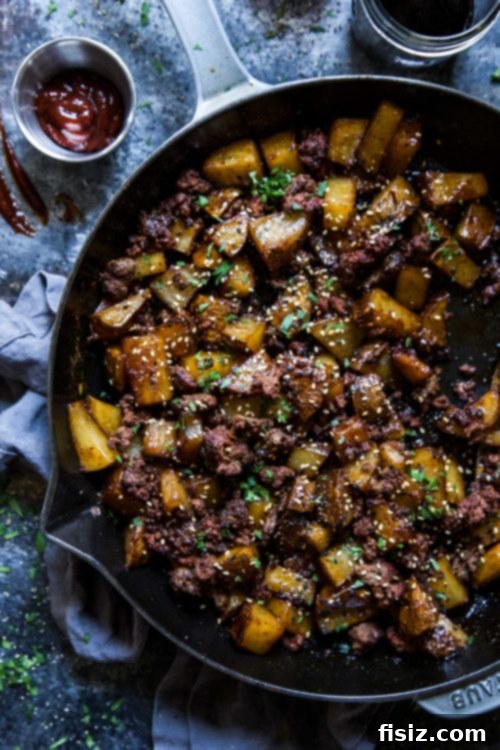 Gochujang Chorizo Loaded Fries 3 Close-up of golden brown potatoes cooking in a skillet