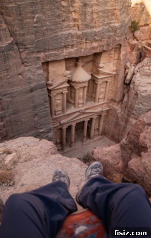 Petra Jordan Stay Dine and Discover the Rose City 18 Traveler enjoying the view of The Treasury from a high vantage point