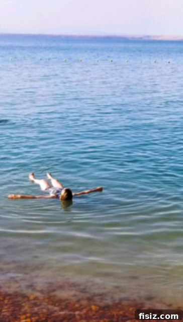 Dead Sea Jordan Accommodations Dining and Attractions 19 A person floating in the Dead Sea reading a newspaper, an iconic pose