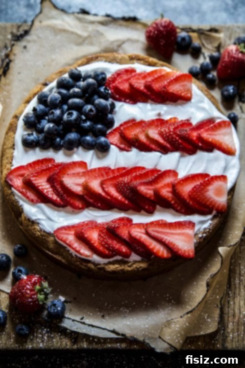 Stars & Stripes Cookie Cake with Fluffy Marshmallow Topping 3 Close-up of the American Flag Cookie Cake design with fresh strawberries and blueberries.