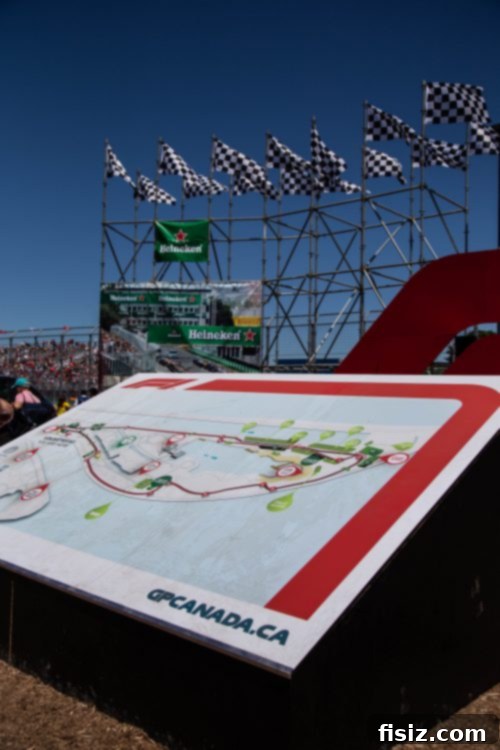 Panoramic view of the Circuit Gilles Villeneuve track during an F1 race, with cars approaching a turn.