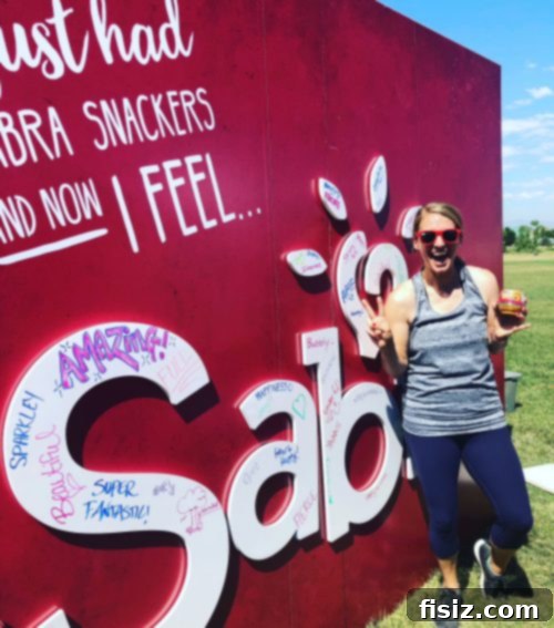 A person holding a sign that says 'I just had Sabra snackers and now I feel...' with happy expressions.
