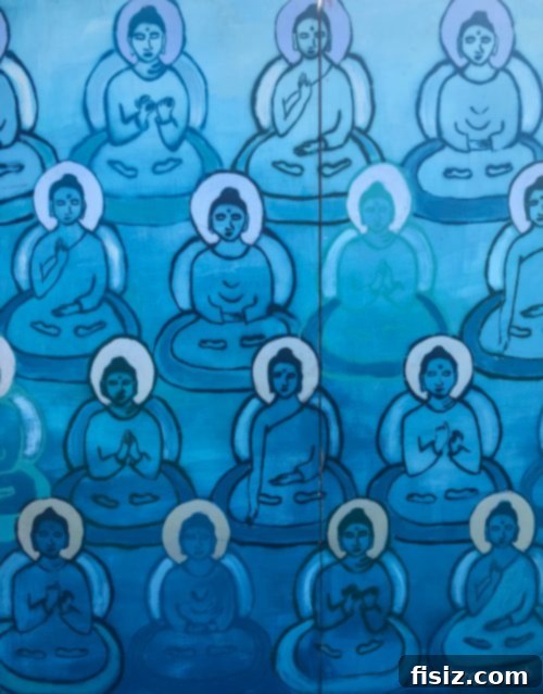 A large group of people meditating peacefully on a grassy field.