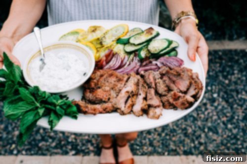 Zesty Grilled Butterflied Leg of Lamb 2 Delicious Grilled Citrus Butterflied Leg of Lamb served on a platter for a gathering