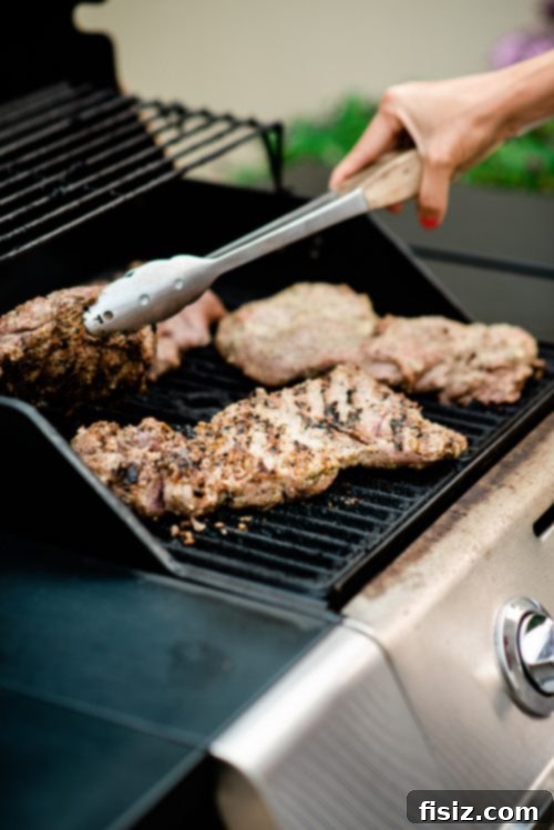 Zesty Grilled Butterflied Leg of Lamb 7 Guests interacting and enjoying the cheerful party atmosphere in a backyard