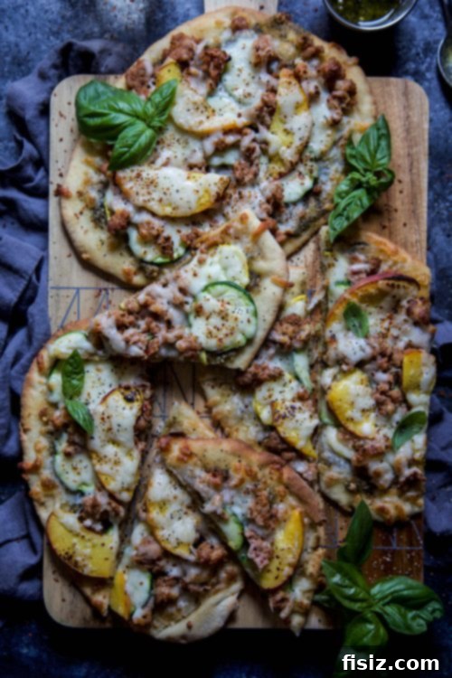 Sweet and Savory Chicken Pesto Flatbread with Summer Peaches and Squash 2 Delicious chicken pesto flatbread with fresh summer squash and juicy peach slices, garnished with basil.