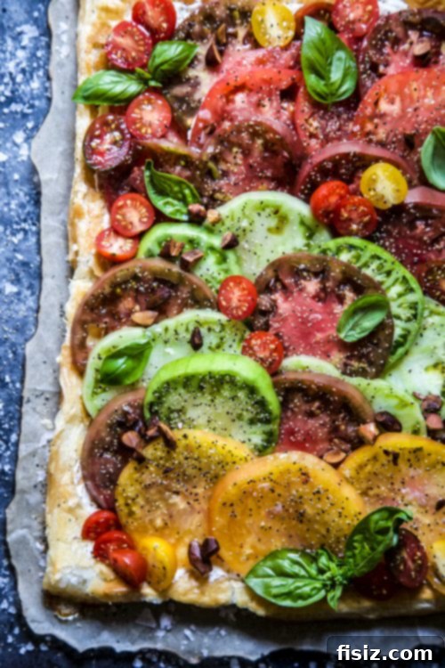 Effortless Tomato Tart with Almond Vinaigrette 3 Lush tomato plants in a garden box, ready for harvest