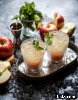 Harvest Apple Rum Cooler 6 A close-up of the finished Apple Cider Rum Cooler, with ice, garnished with mint and an apple slice.