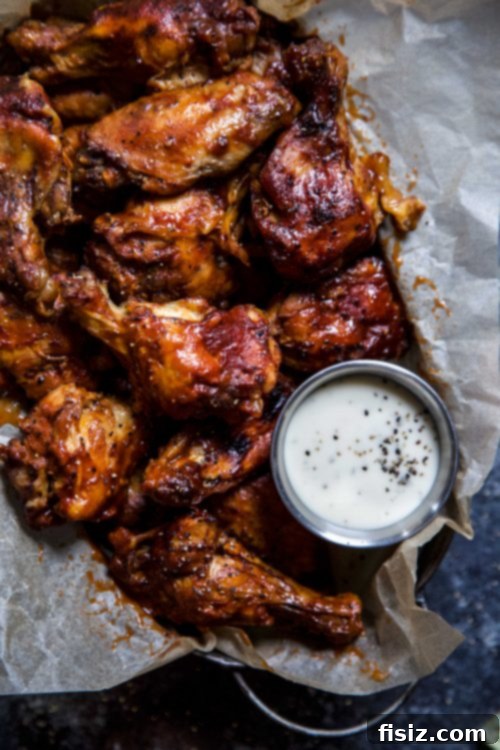 Tender Slow Cooker Chipotle Bourbon Chicken Wings 4 Close-up shot of perfectly cooked Slow Cooker Chipotle Bourbon Chicken Wings in a bowl, garnished with cilantro.