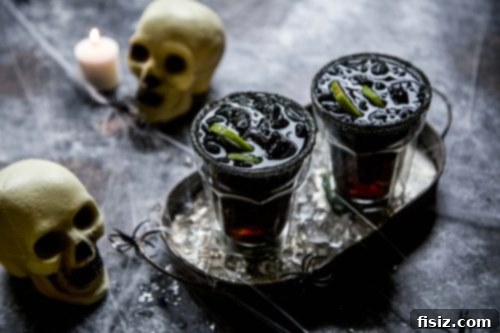 Fright Night Margarita 6 A close-up of a festive Halloween Margarita with a black salt rim and lime garnish, alongside a small pumpkin and autumn leaves, capturing the essence of a spooky celebration.