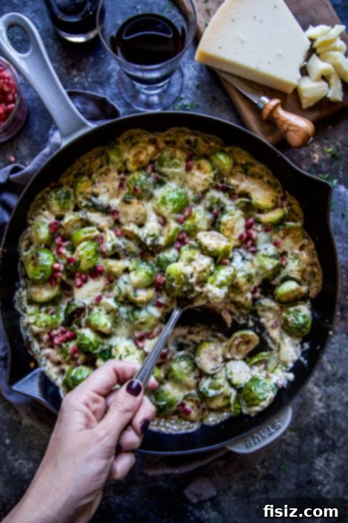 Freshly cooked Vegetarian Brussels Sprout Bake with Parmesan and Pomegranates, garnished with fresh parsley.