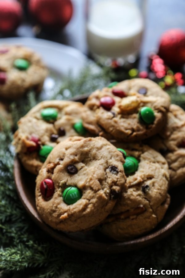 Santa's Cookie Catastrophe 5 A close-up view of freshly baked Santa's Trashed Up Cookies, highlighting the melted chocolate chips and colorful M&Ms