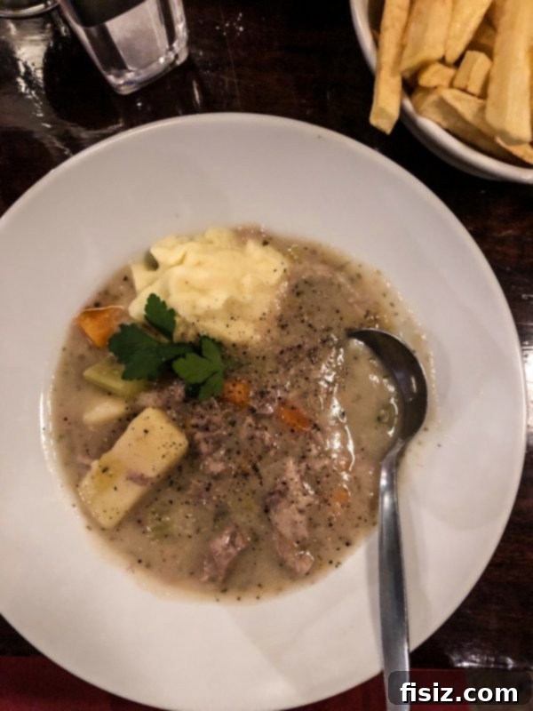The Ultimate Dublin Guide Stay Dine and Explore Ireland's Capital 17 A delicious bowl of Irish stew with bread, served in a pub setting