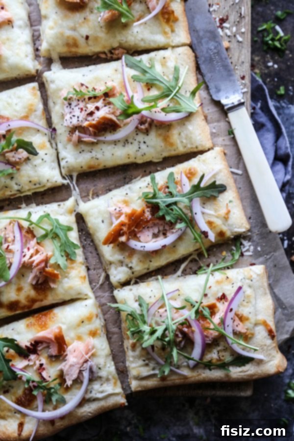 Overhead shot of Smoked Salmon White Pizza, highlighting the creamy base and toppings