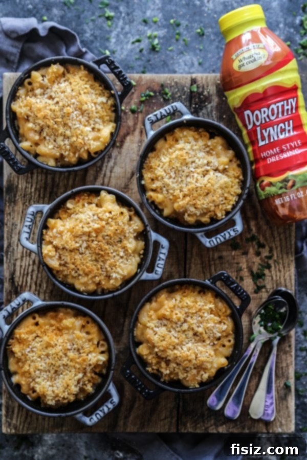 Dorothy Lynch's Signature Mac & Cheese 4 A serving of Dorothy Lynch Mac & Cheese, showing off the perfectly melted cheese and golden crumb topping in individual cocottes.