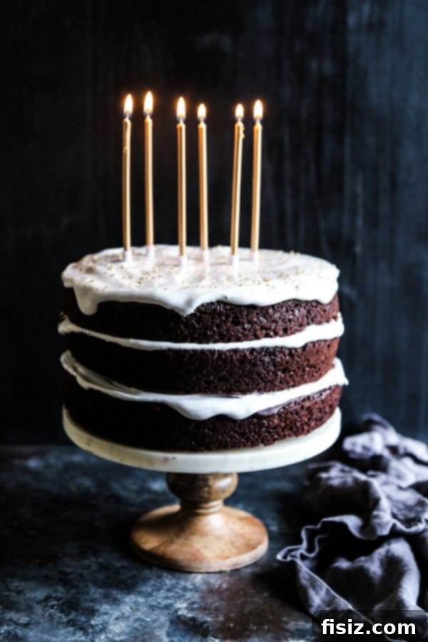 Decadent Dark Chocolate Cake with Fluffy Marshmallow Frosting 5 Slice of Dark Chocolate Cake with marshmallow frosting on a plate