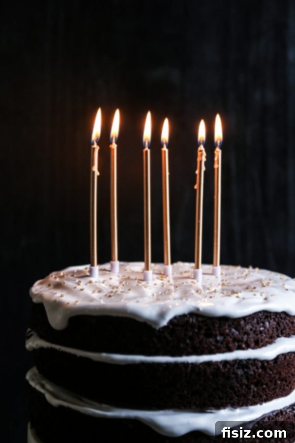 Decadent Dark Chocolate Cake with Fluffy Marshmallow Frosting 7 Three-tiered Ultimate Dark Chocolate Cake with glossy marshmallow frosting