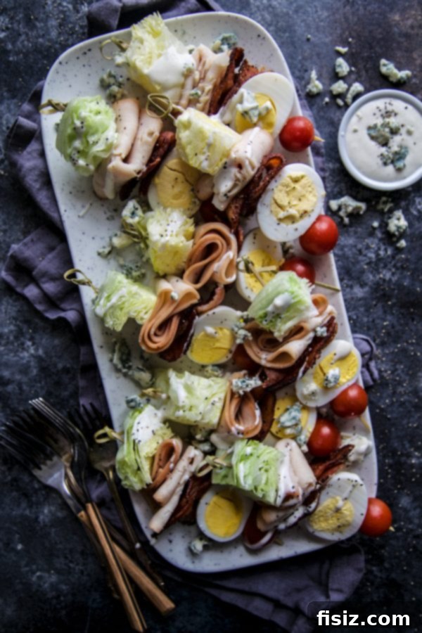 Rotisserie Chicken Cobb Skewers 2 Freshly prepared Rotisserie Seasoned Chicken Breast Cobb Salad Skewers on a white platter