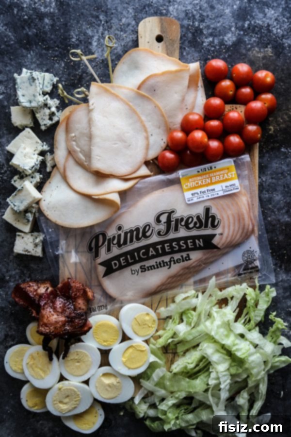 Rotisserie Chicken Cobb Skewers 4 Hand holding a Rotisserie Seasoned Chicken Breast Cobb Salad Skewer