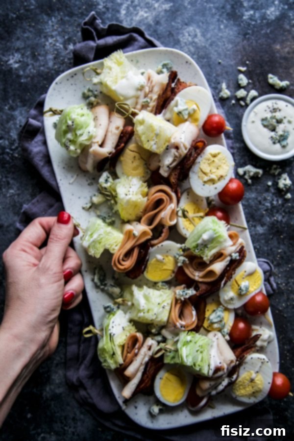 Rotisserie Chicken Cobb Skewers 6 Assortment of Rotisserie Seasoned Chicken Breast Cobb Salad Skewers on a rustic wooden board