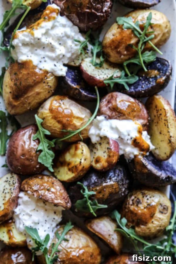 Zesty Tamarind Butter Roasted Spring Potatoes 3 Spring Roasted Potatoes with Tamarind Butter garnished with fresh arugula and burrata.