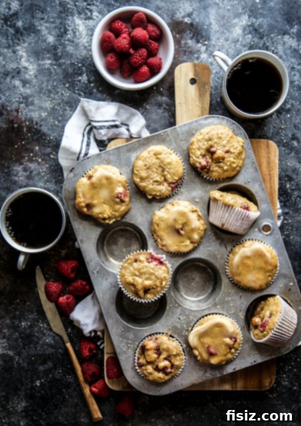 Golden Raspberry Oat Muffins with Honey Butter 6 Close-up of Raspberry Oat Muffins served with a generous dollop of honey butter